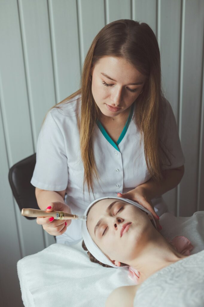 Female therapist injecting enzymes and with dermapen